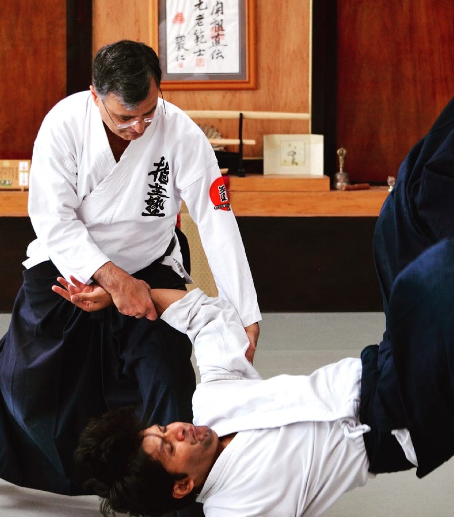 Martial artist in full gear practicing kicks in a sunlit dojo. Perfect for sports and fitness themes.